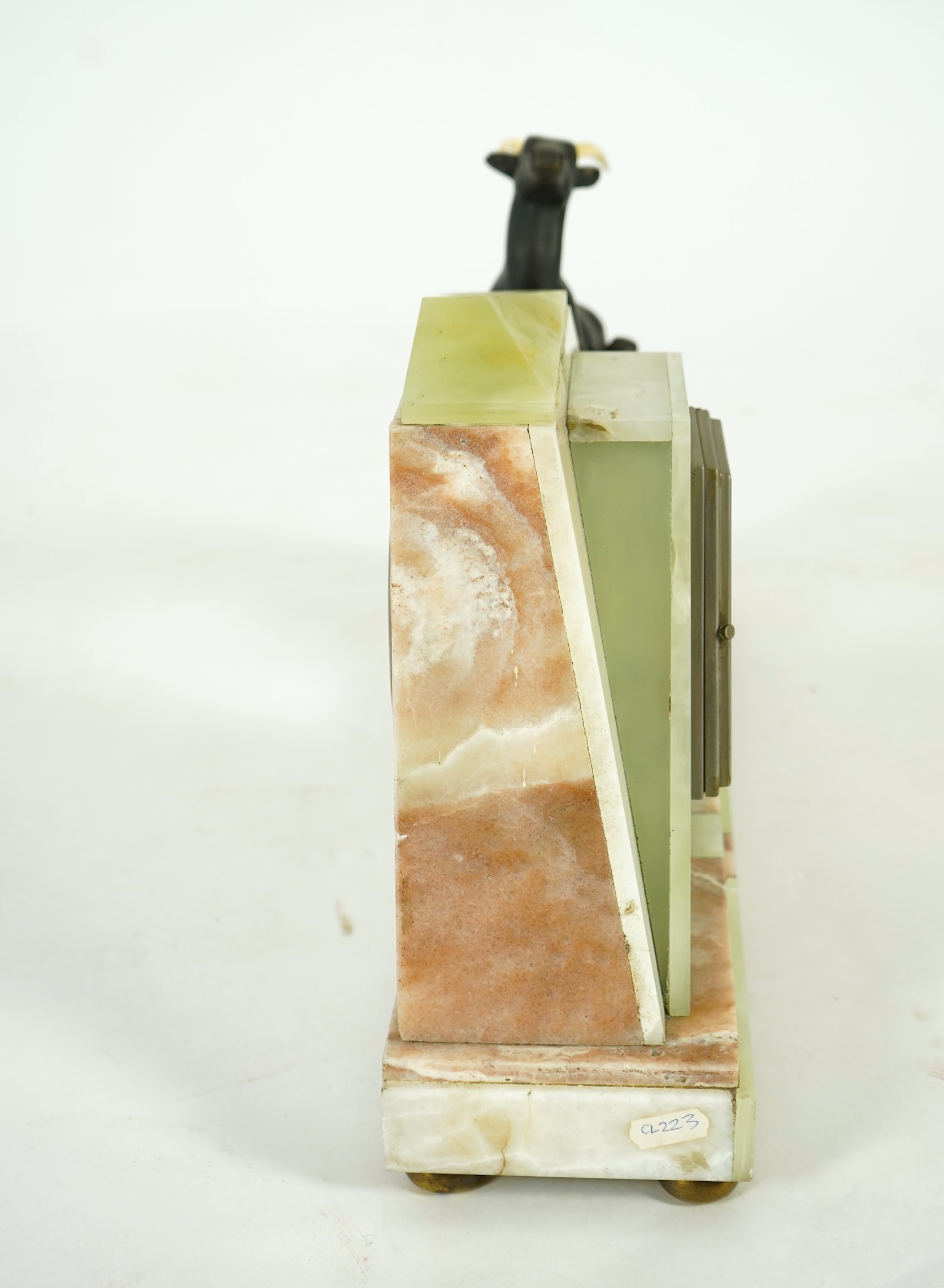 Attributed to Uriano (Ugo Cipriani, Italian, 1897-1960), a French green and cream onyx pyramid shaped clock